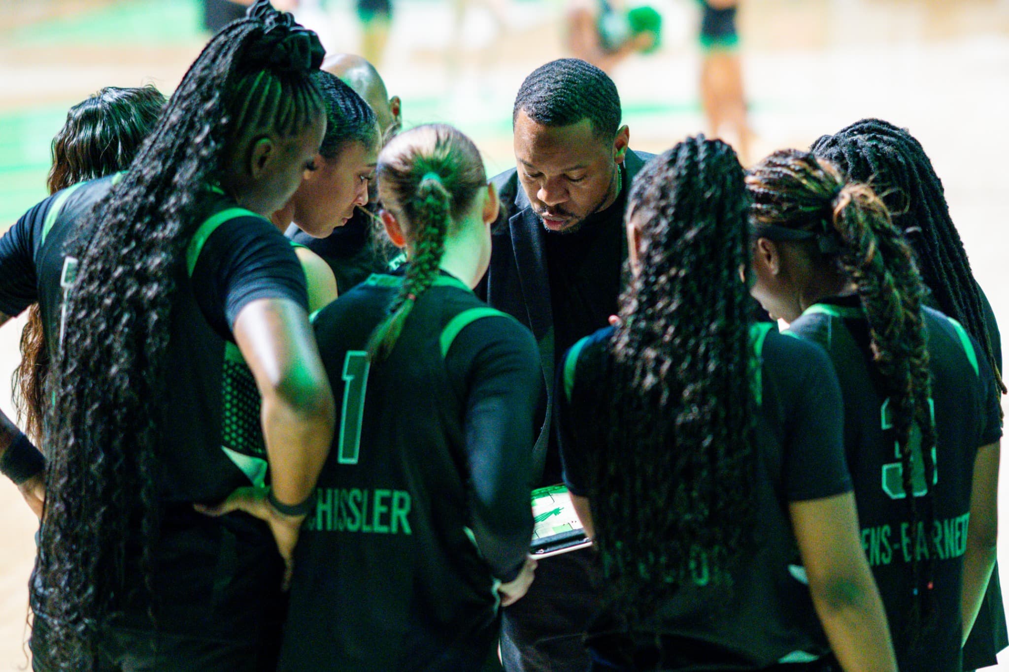 The North Texas team huddled around their coach